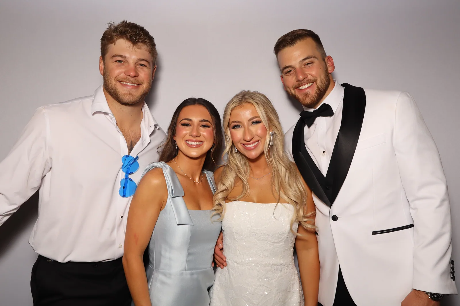 Wedding group with white tux, color glam booth