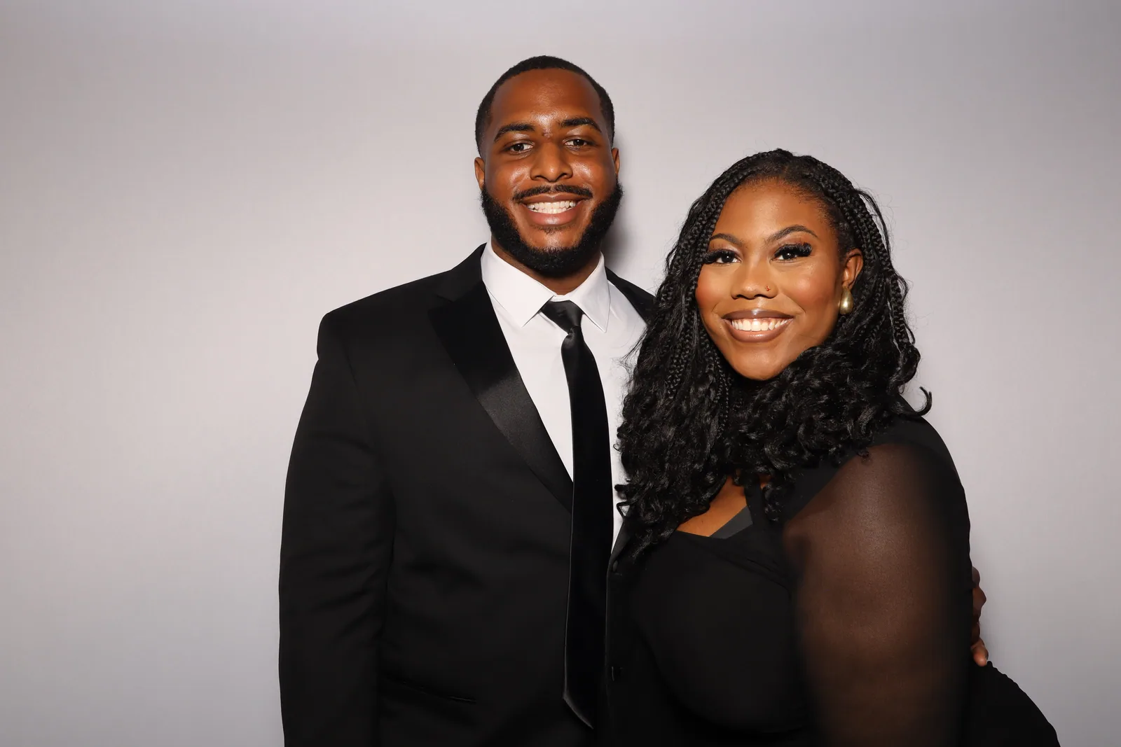 Couple in tux and black mesh, color glam portrait