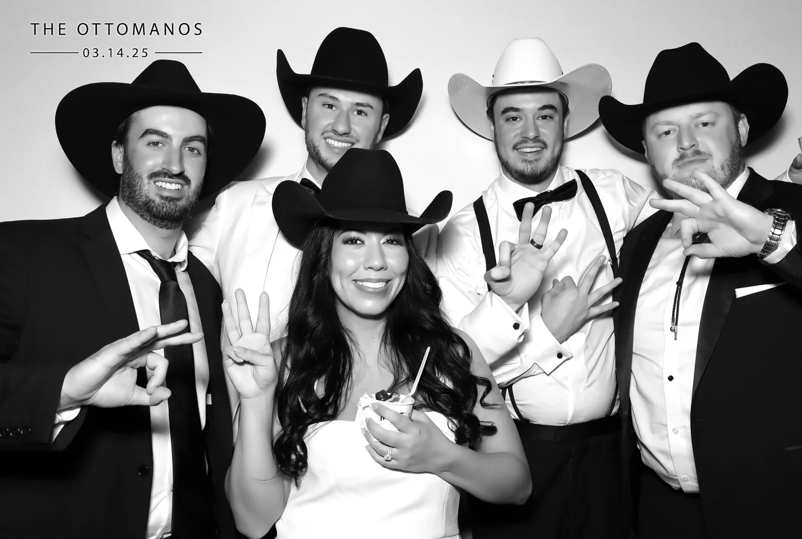 Guests in cowboy hats with bride, Texas glam photo booth