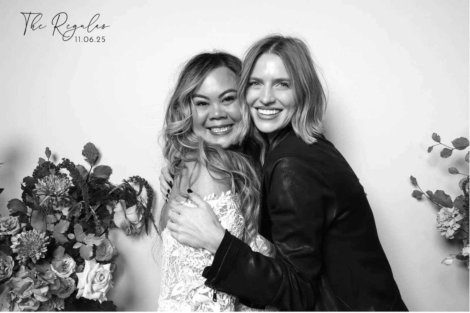 Two guests laughing and hugging, glam booth